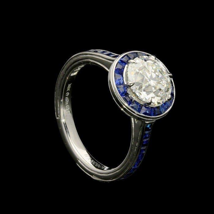 A beautiful 2.02ct old cut diamond and calibre cut sapphire halo ring set in platinum
