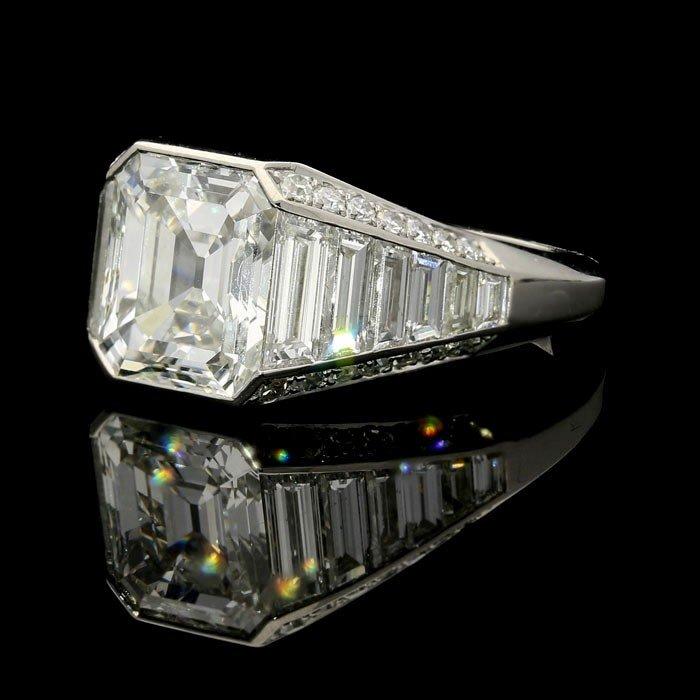 A stunning 3.02ct emerald cut diamond ring with tapering baguette and single cut diamond shoulders