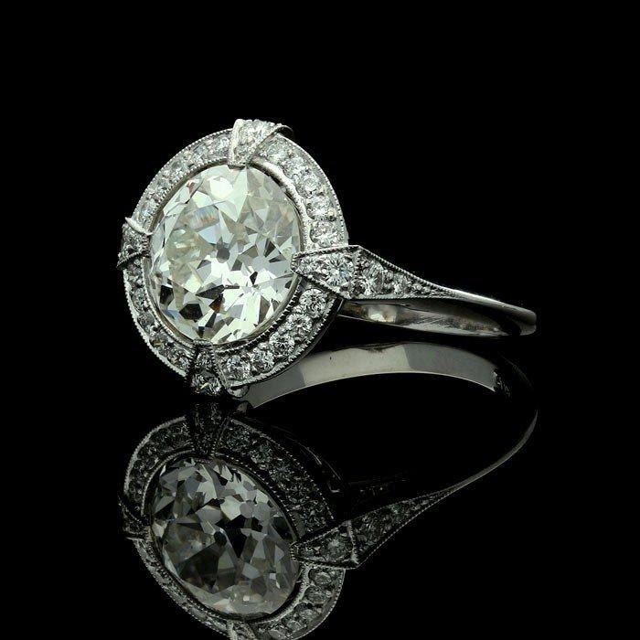 A stunning round 3.14ct old European cut diamond halo cluster ring in platinum