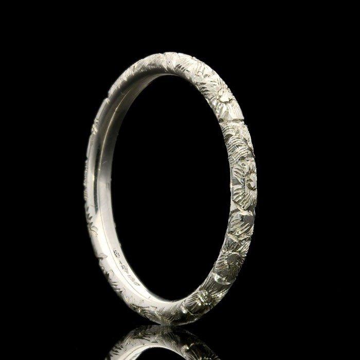 A prettily patterned platinum wedding ring with Georgian style floral engraving