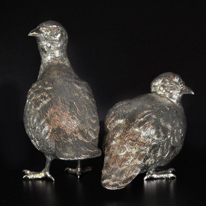 A pair of finely modelled English partridges in sterling silver