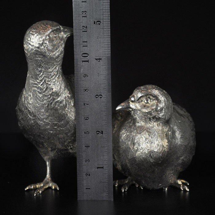 A pair of finely modelled English partridges in sterling silver