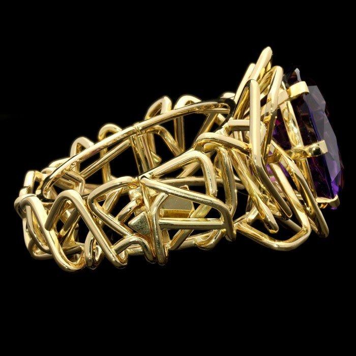 A fabulous 123.70ct cushion cut amethyst and 18ct yellow gold Disorient statement bangle
