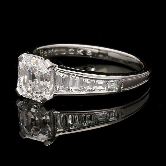 An elegant 1.66ct Asscher cut diamond ring with tapered diamond-set shoulders