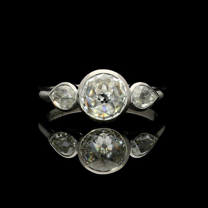 An unusual 1.01ct round and pear shape rose-cut diamond ring set in a handmade platinum mount