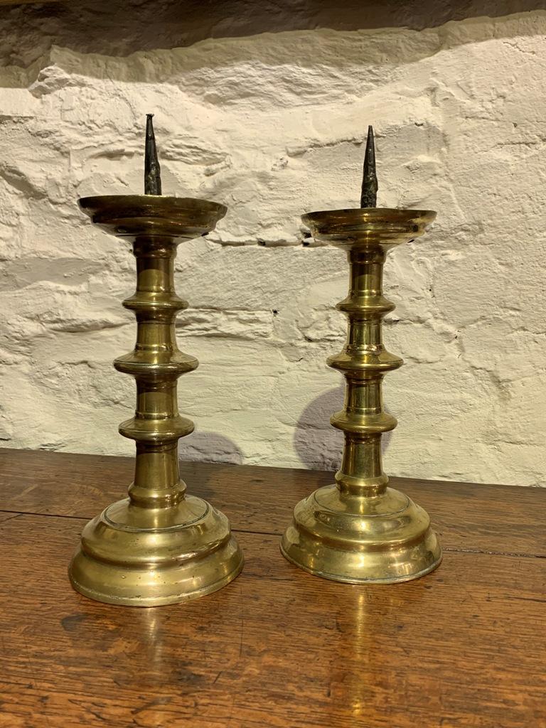 A MAGNIFICENT PAIR OF EARLY 16TH CENTURY NUREMBERG PRICKET CANDLESTICKS WITH TRIPLE KNOBBED STEMS. CIRCA 1520.