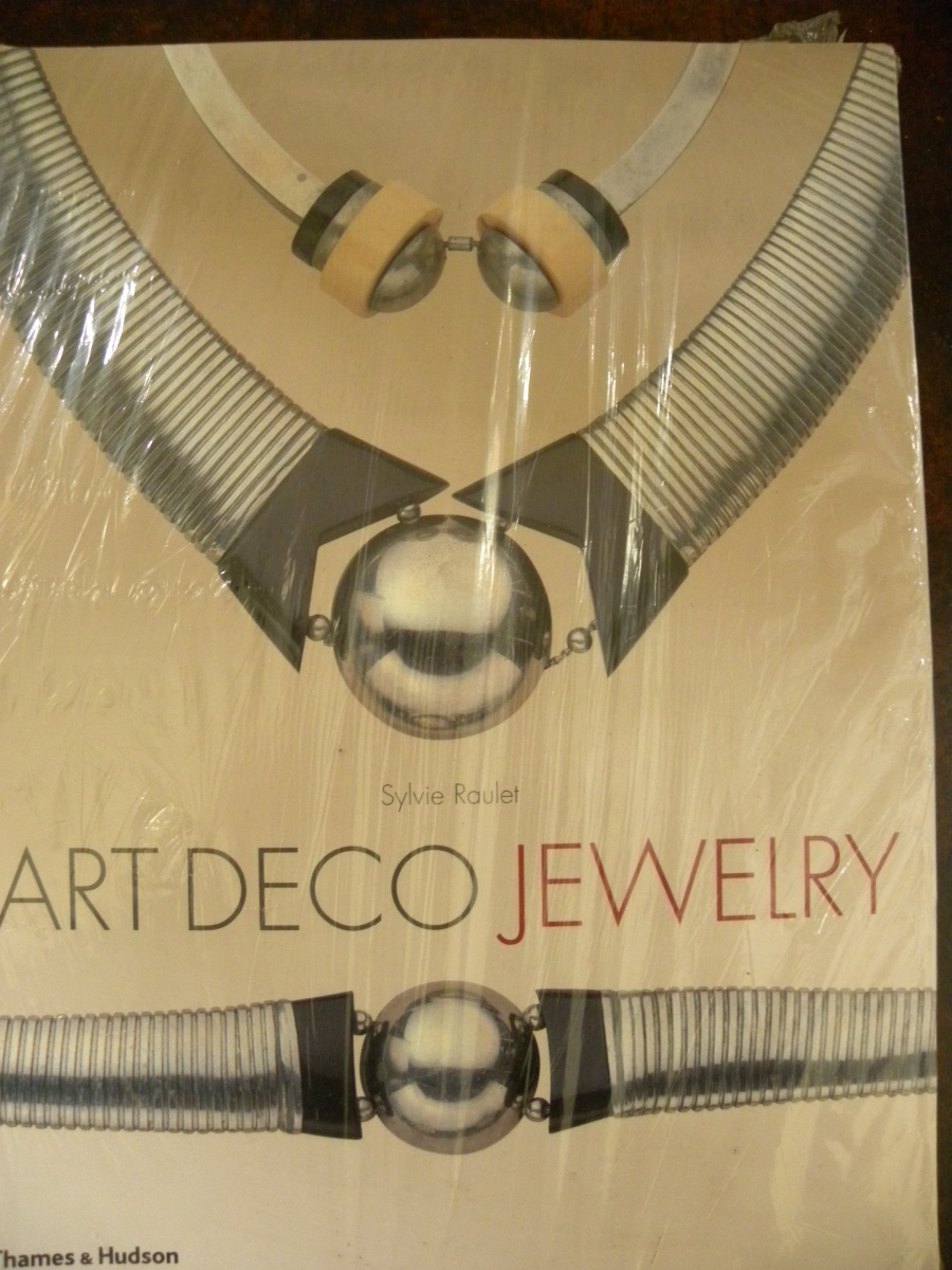 Art Deco Jewelry By Sylvie Raulet  800 illustrations support the text of this unused and still sealed paperback book about Art Deco jewellery and includes biographies of most of  the influential jewellers of the day.  A copy of this book, inland post free for £29.95 can be ordered by contacting rogerheathbullock@gmail.com or by phone to 07968 274556 