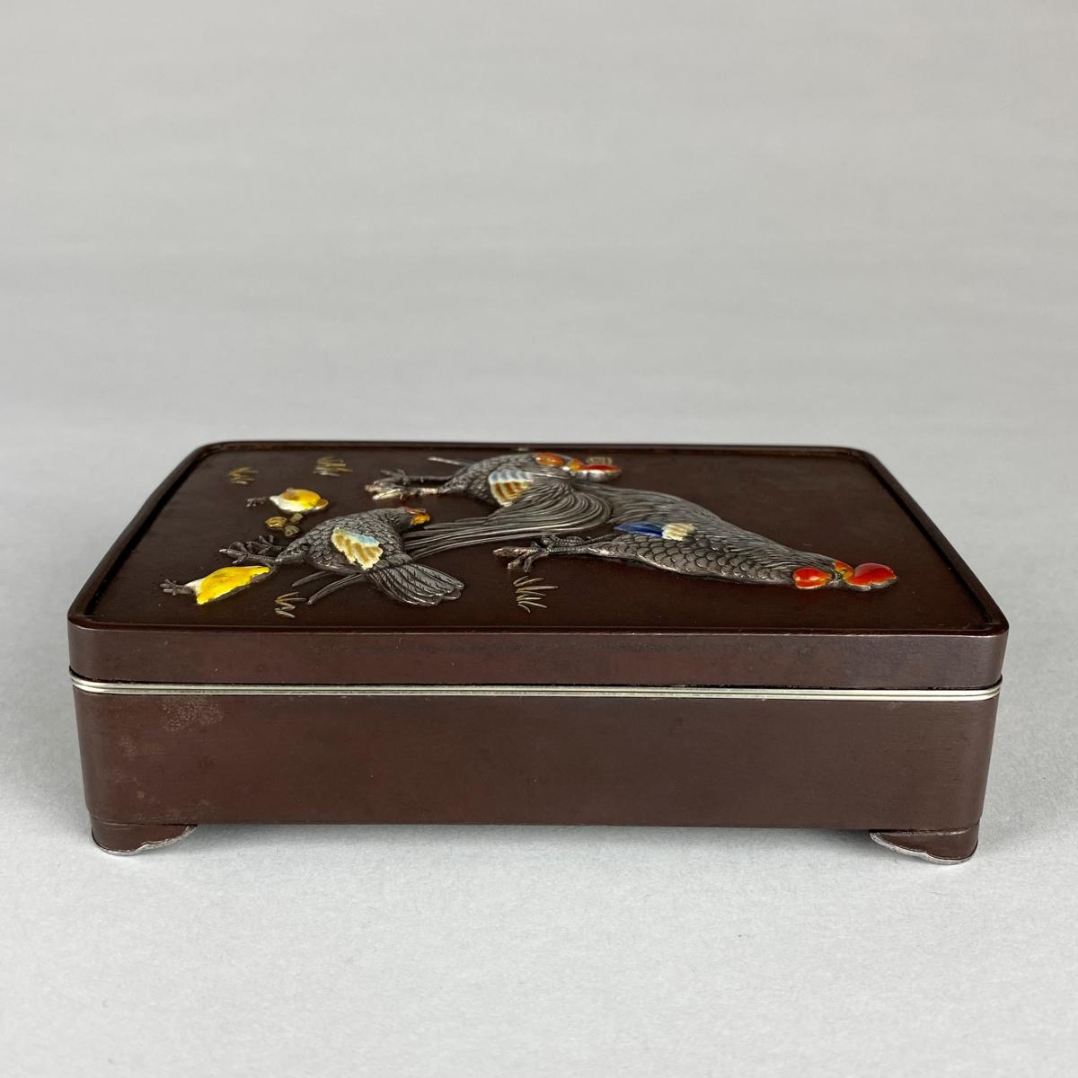 A Japanese multi metal decorative box and cover depicting a family of chickens