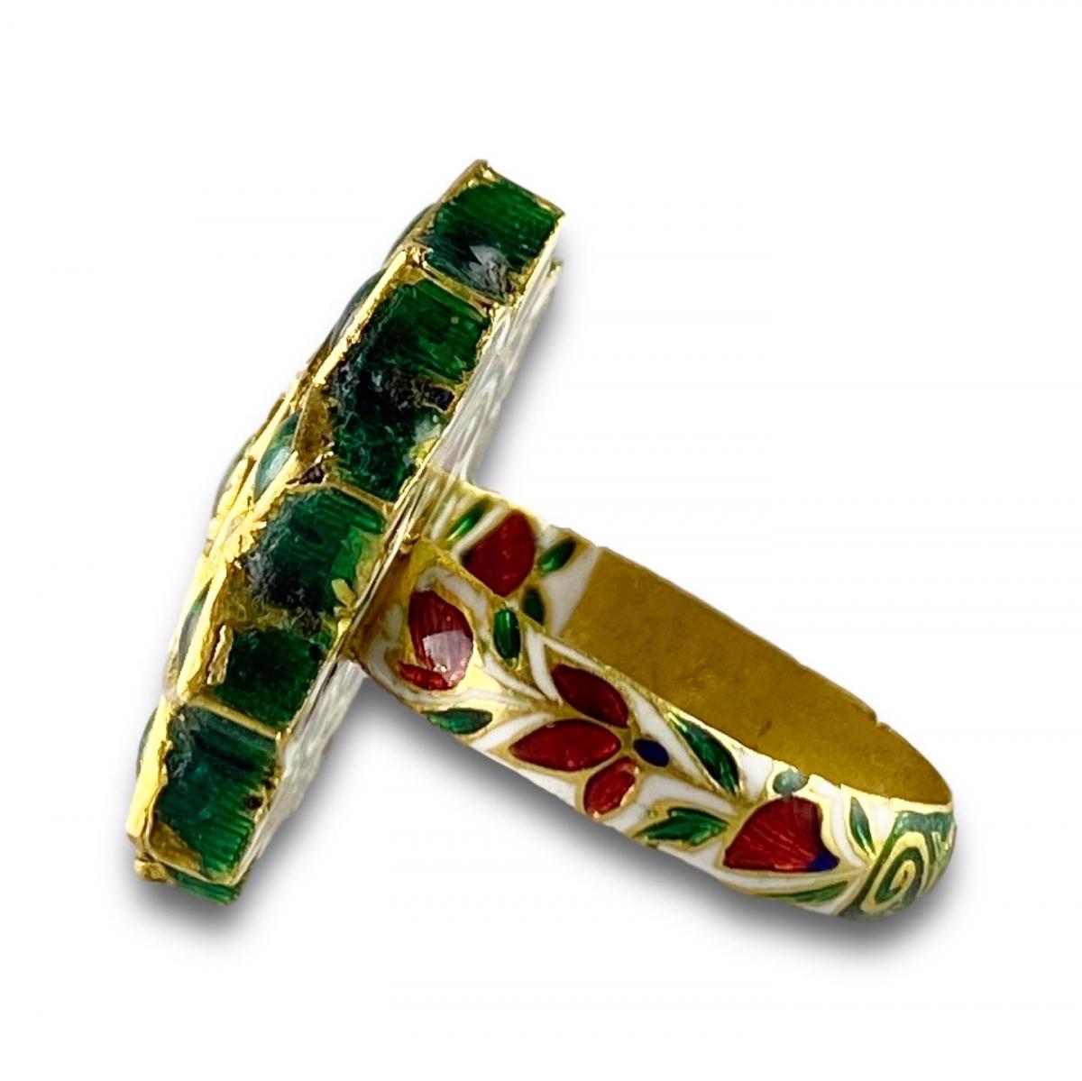 A foiled emerald, paste & enamel ring. Indian, early 20th century