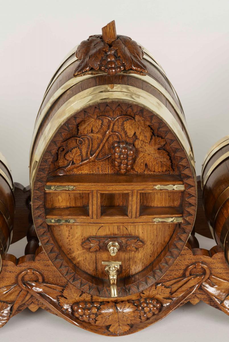 A Carved Oak Barrel Drinks Set