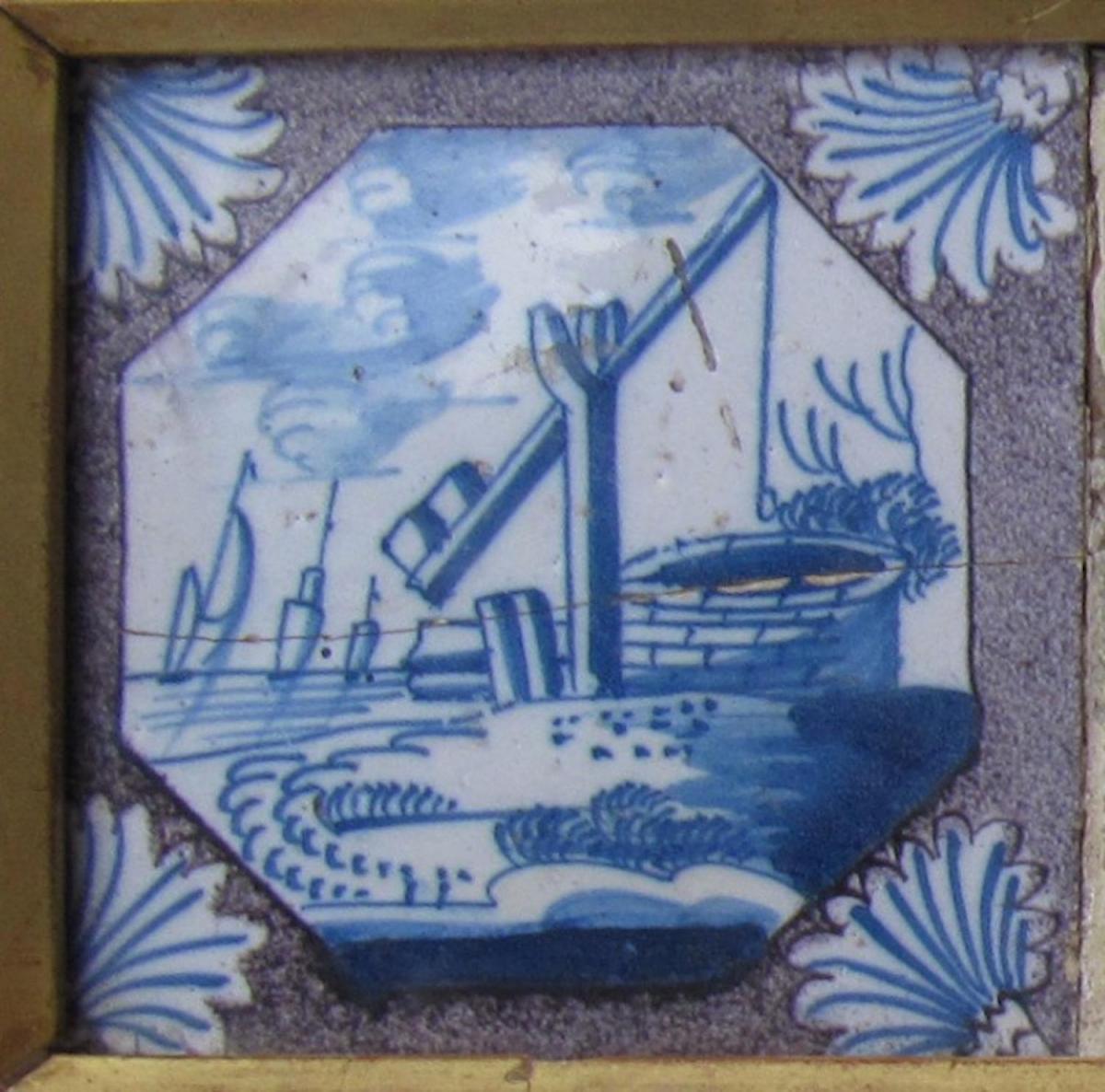 A set of four 18th century, English manganese delftware tiles in a gilt frame