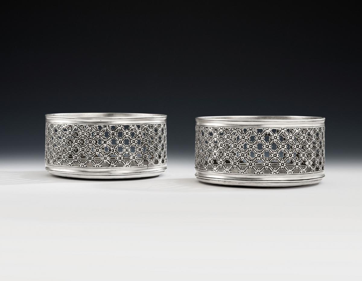 An exceptionally rare and unusual pair of Floral Trellis Work Silver Based Wine Coasters made in London in 1852 by Daniel & Charles Houle