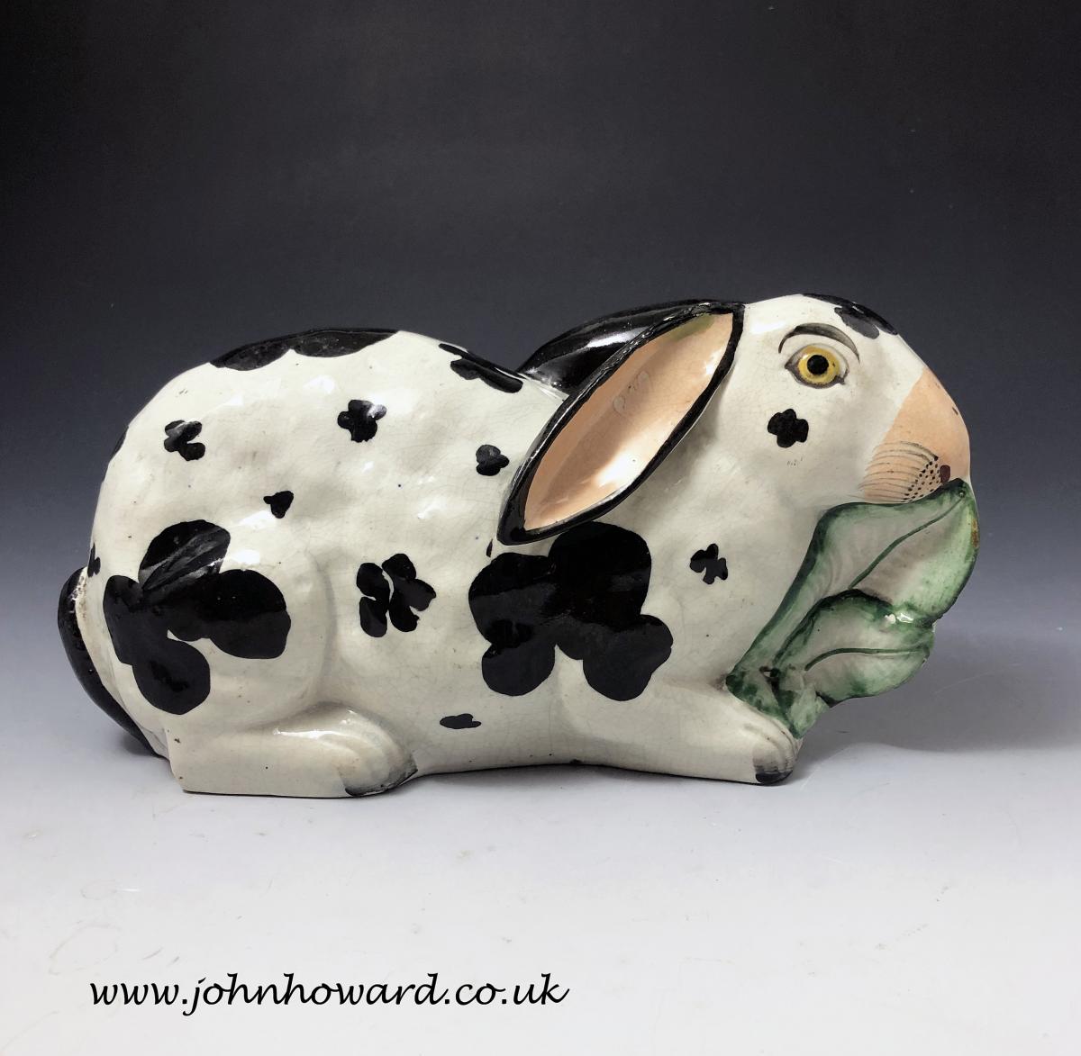 Staffordshire pottery figure of a rabbit nibbling on leaves mid 19th century