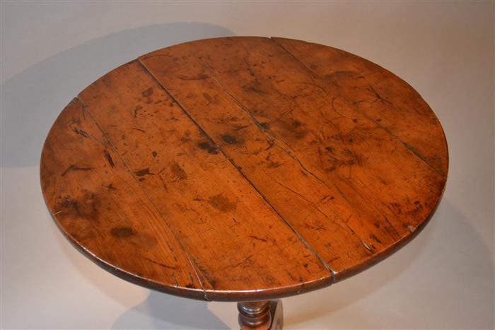 An early 19th century yew wood tripod table