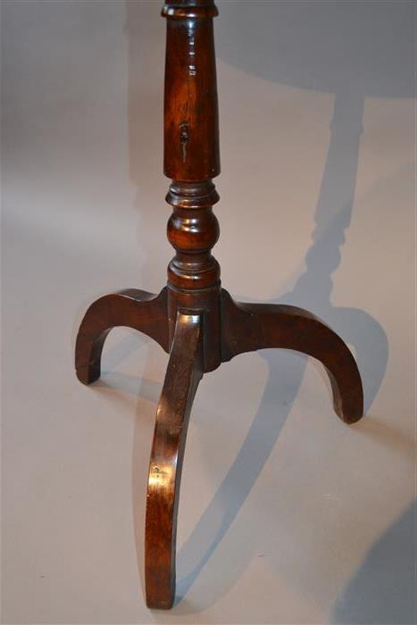 An early 19th century yew wood tripod table