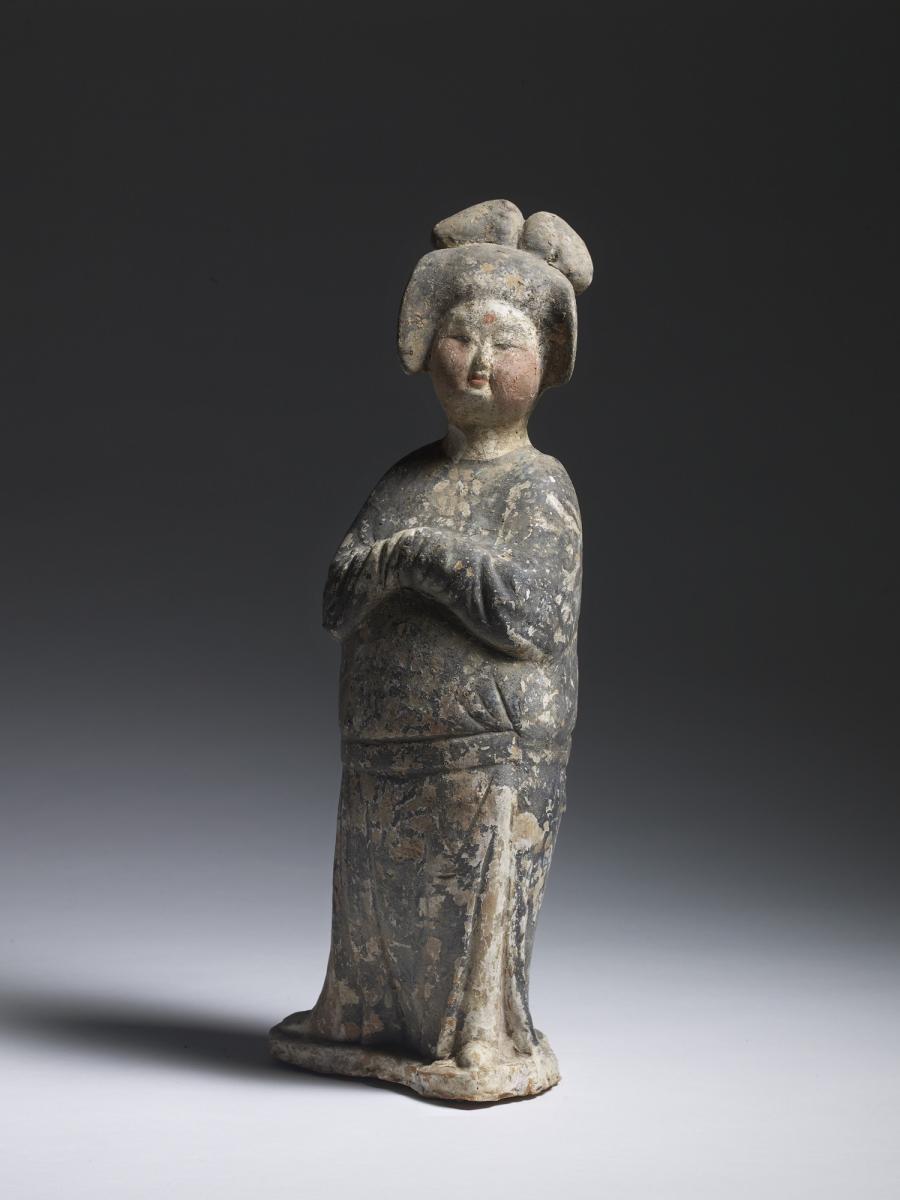 A Chinese Unglazed Pottery Figure of a Court Lady, Tang Dynasty