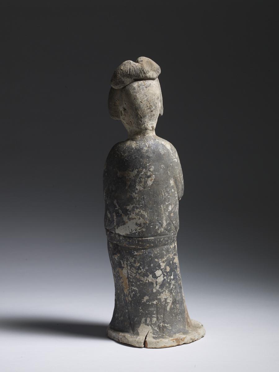 A Chinese Unglazed Pottery Figure of a Court Lady, Tang Dynasty