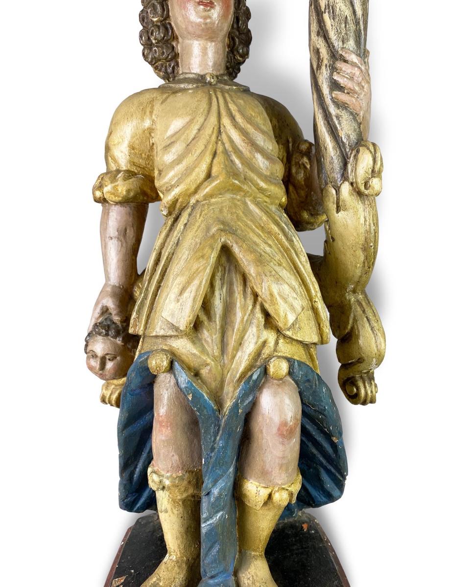 Polychromed wooden torchere bearing angel. Spanish, late 17th century