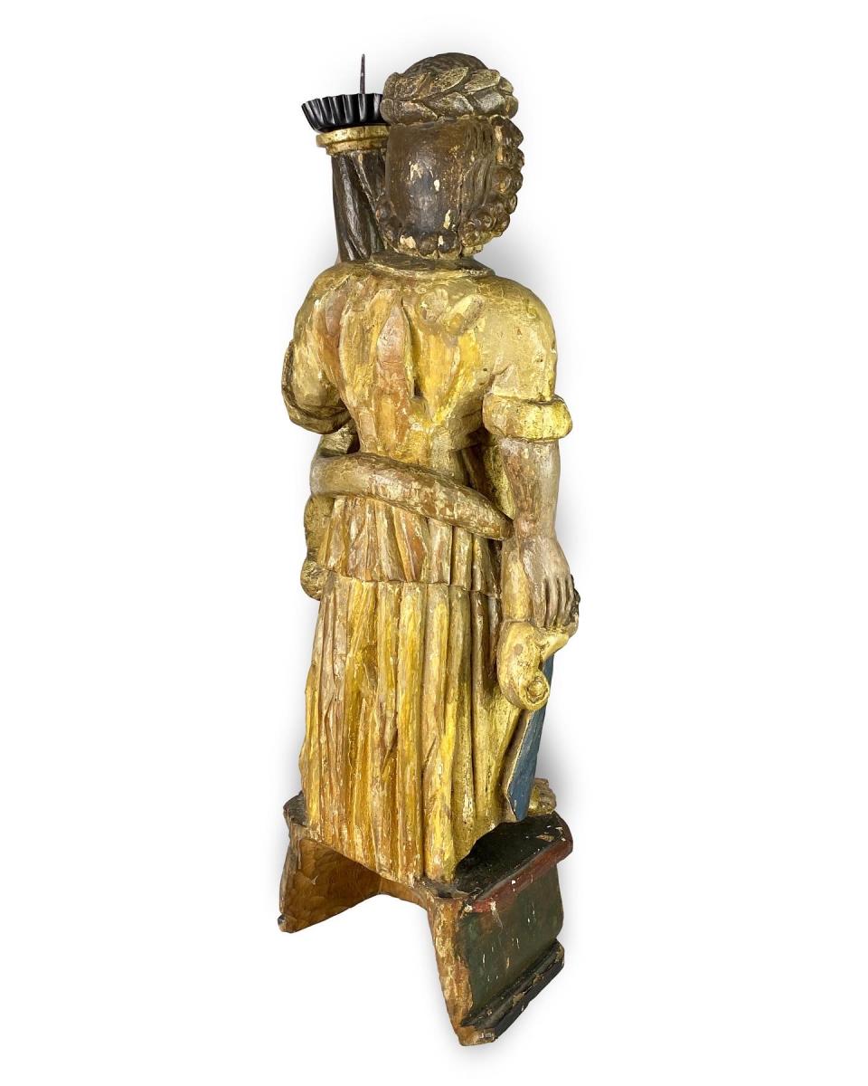 Polychromed wooden torchere bearing angel. Spanish, late 17th century