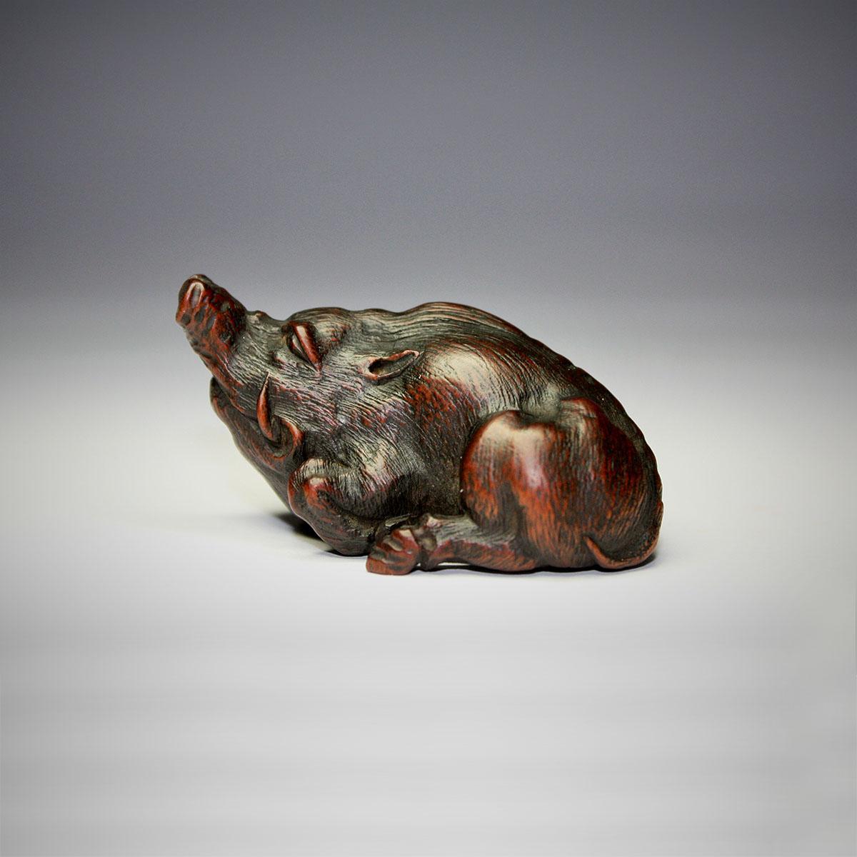 Wood Netsuke of a Recumbent Boar, by Sato Masatomo
