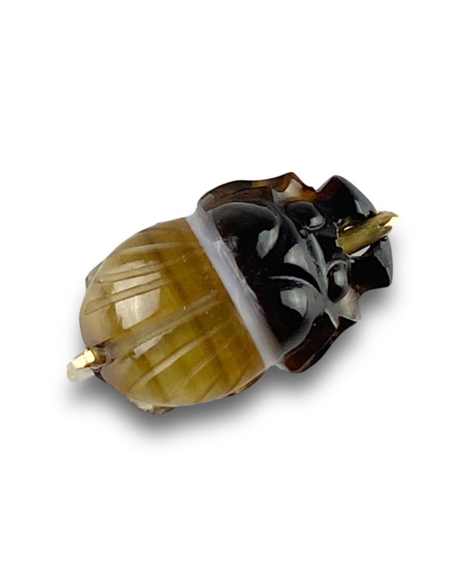 Gold ring set with a banded agate scarab amulet. French, 20th century