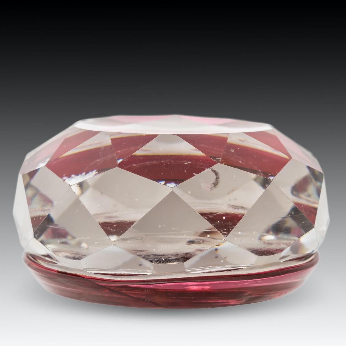 A Baccarat huntsman sulphide paperweight on translucent red ground