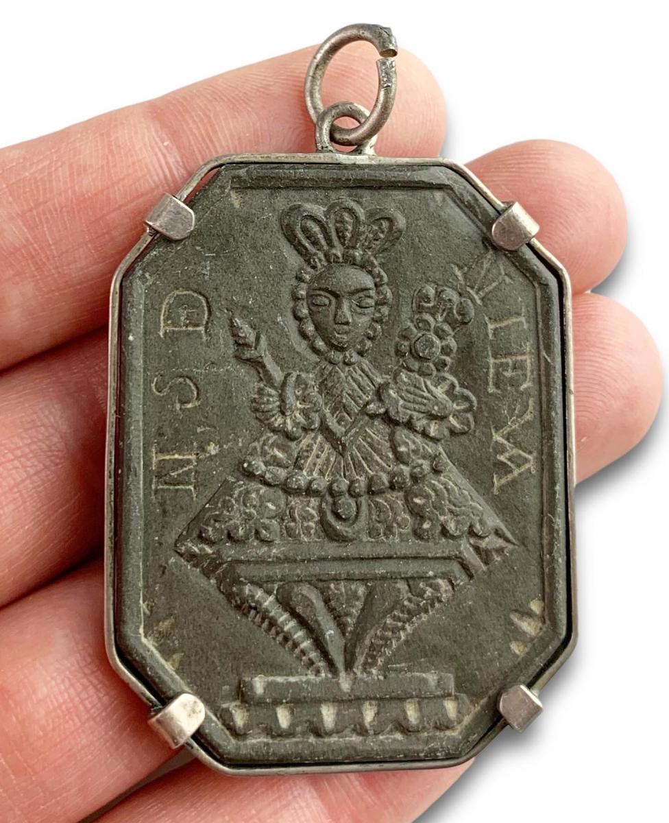Pendant set with a slate relief of Our Lady of Nieva. Spain, 17th century