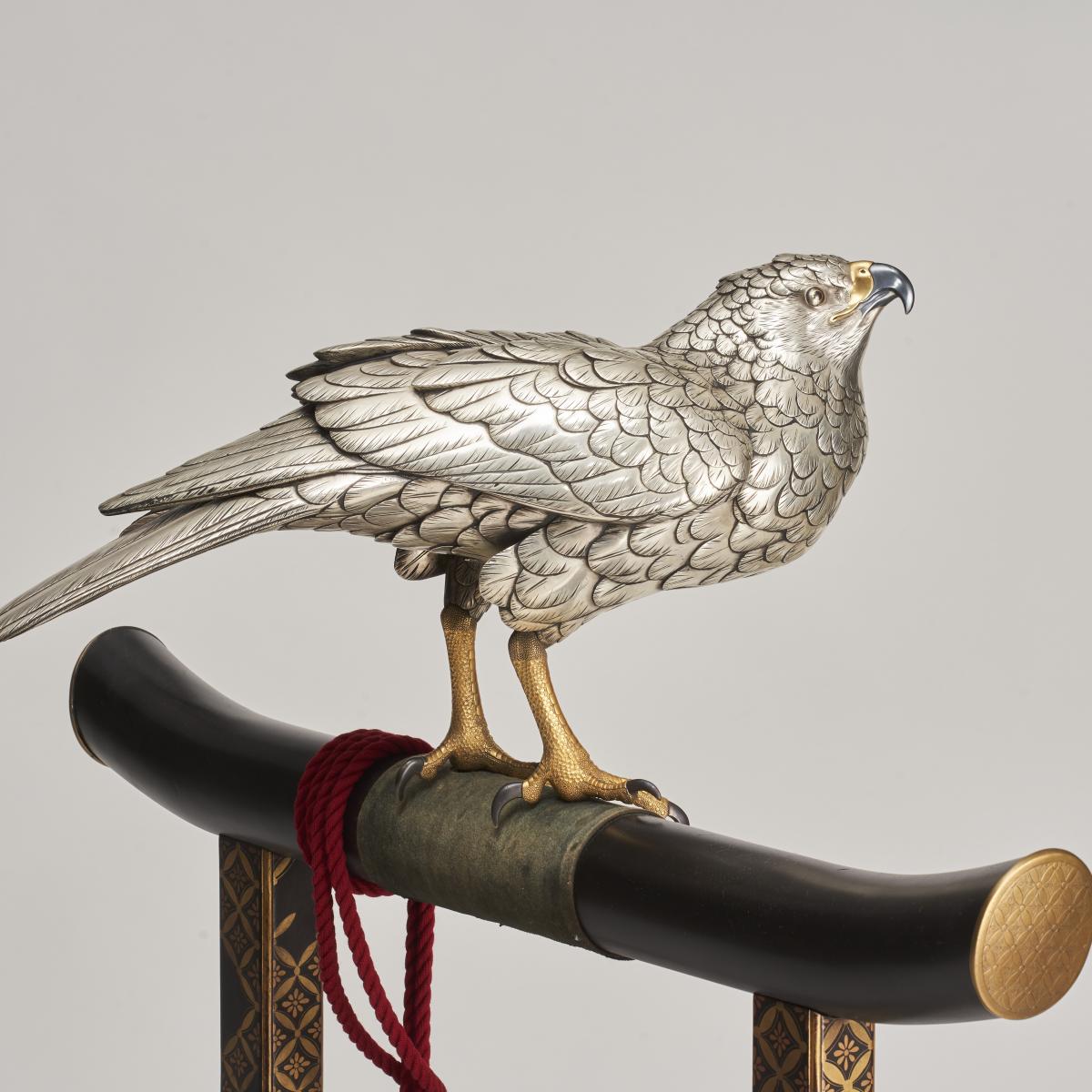 A majestic, life-size silvered Bronze Okimono of a Hawk on a superb lacquer stand, (Japanese Meiji-era)