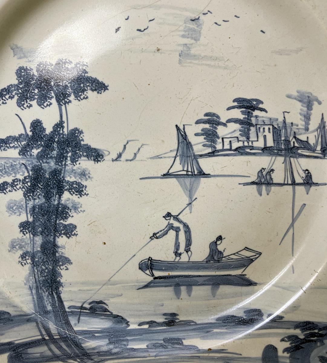 English delftware blue and white charger decorated with a romantic boating scene, Bristol 18th century