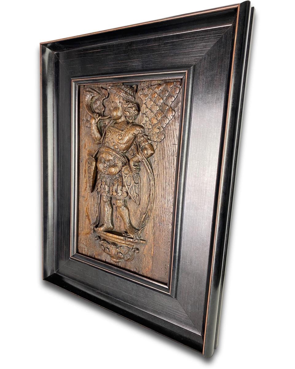 Oak relief of Saint Micheal blowing a horn. French, mid 16th century