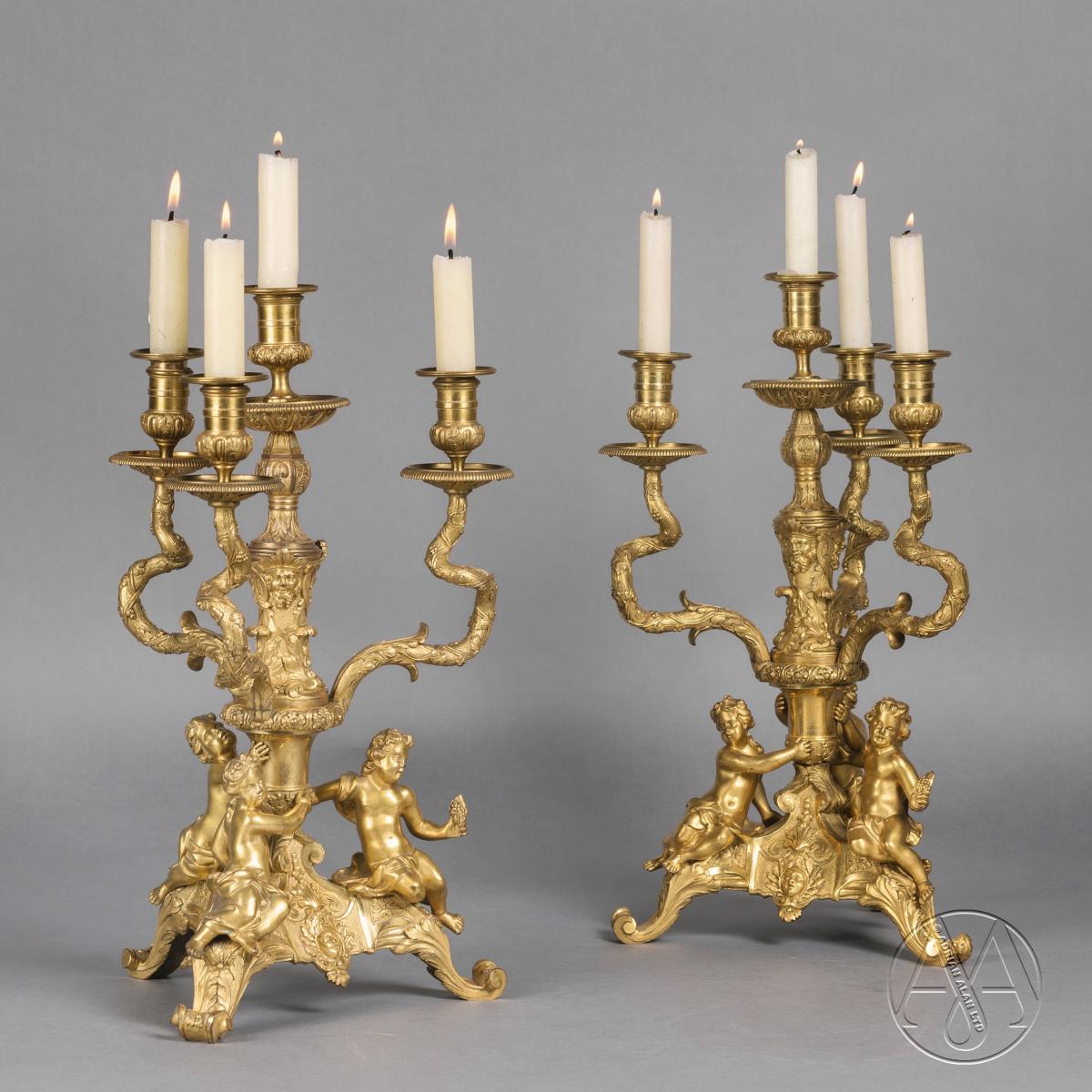 A Fine Pair of Regence Style Gilt-Bronze Figural Four-Light Candelabra
