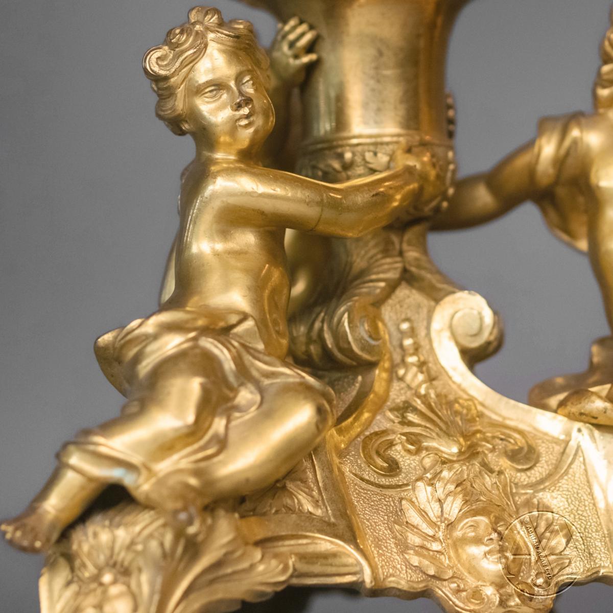 A Fine Pair of Regence Style Gilt-Bronze Figural Four-Light Candelabra