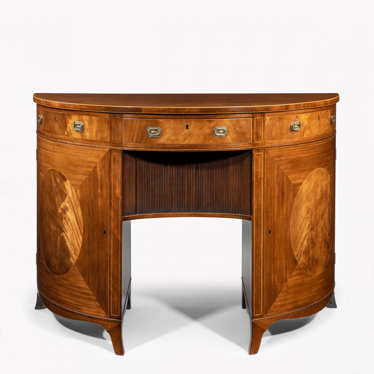 A fine pair of George III figured mahogany side cabinets, in the manner of Thomas Sheraton