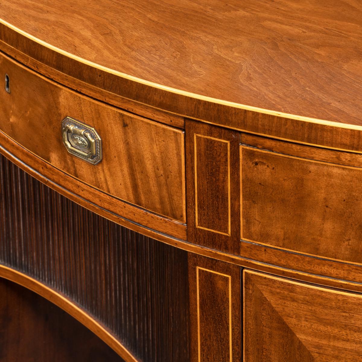 A fine pair of George III figured mahogany side cabinets, in the manner of Thomas Sheraton