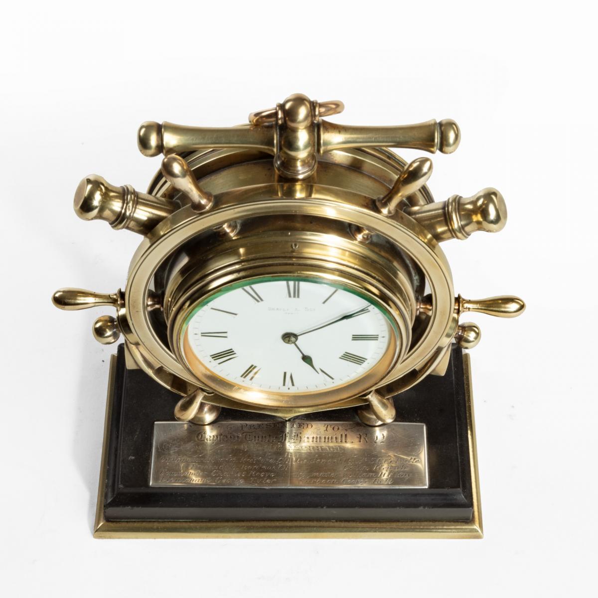 A brass ship’s novelty clock presented to Captain Tynte F Hammill RN