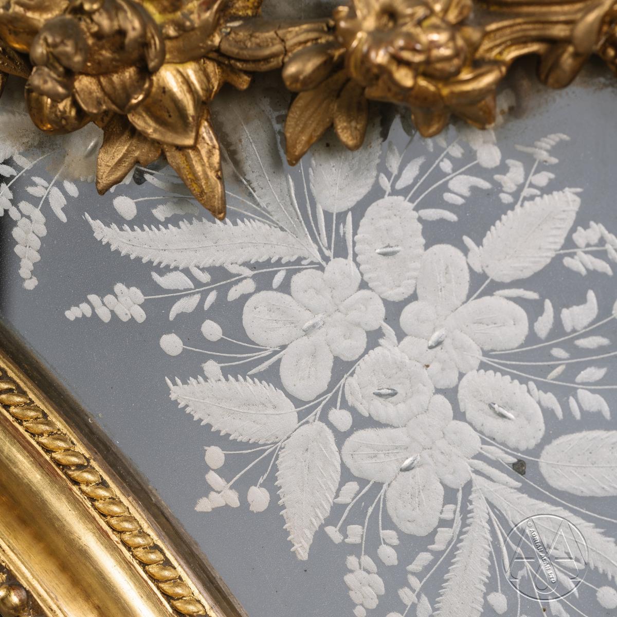 A Louis XIV Style Carved Giltwood Mirror