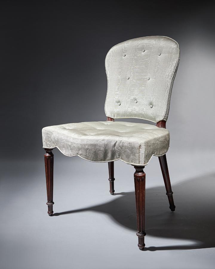 Pair of George III mahogany serpentine upholstered chairs