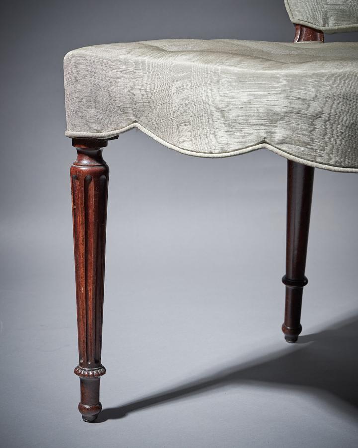 Pair of George III mahogany serpentine upholstered chairs