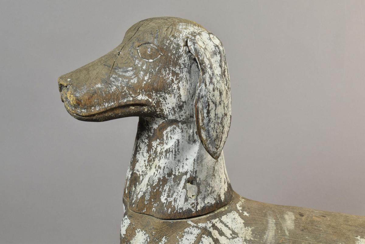 A rare carved wood model of a dog, probably a Talbot hound with the remains of the original painted decoration, c.1800