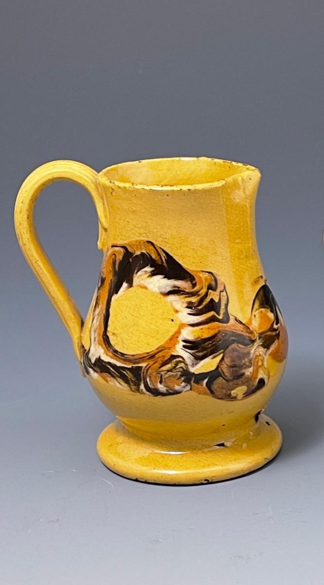 Miniature yellow-ware pottery pitcher with earthworm pattern in slip, early 19th century