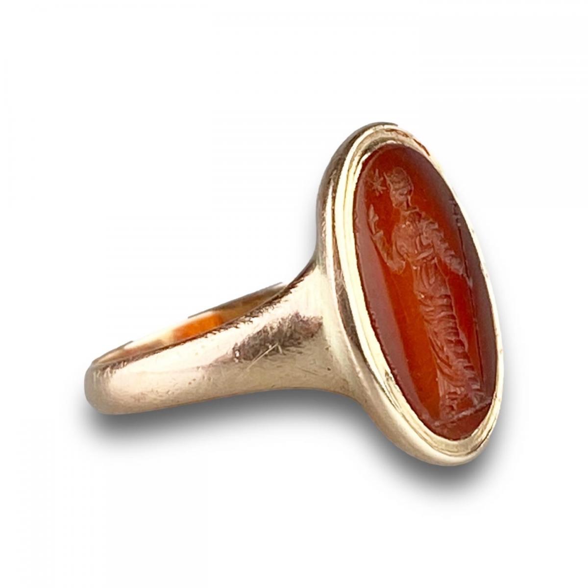 Gold ring with a carnelian intaglio of a woman. Italian, 18th-19th centuries