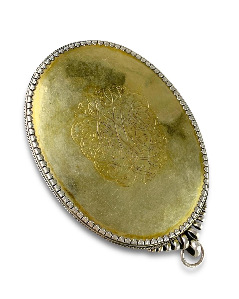 Silver and parcel-gilt travelling mirror. English, circa 1680