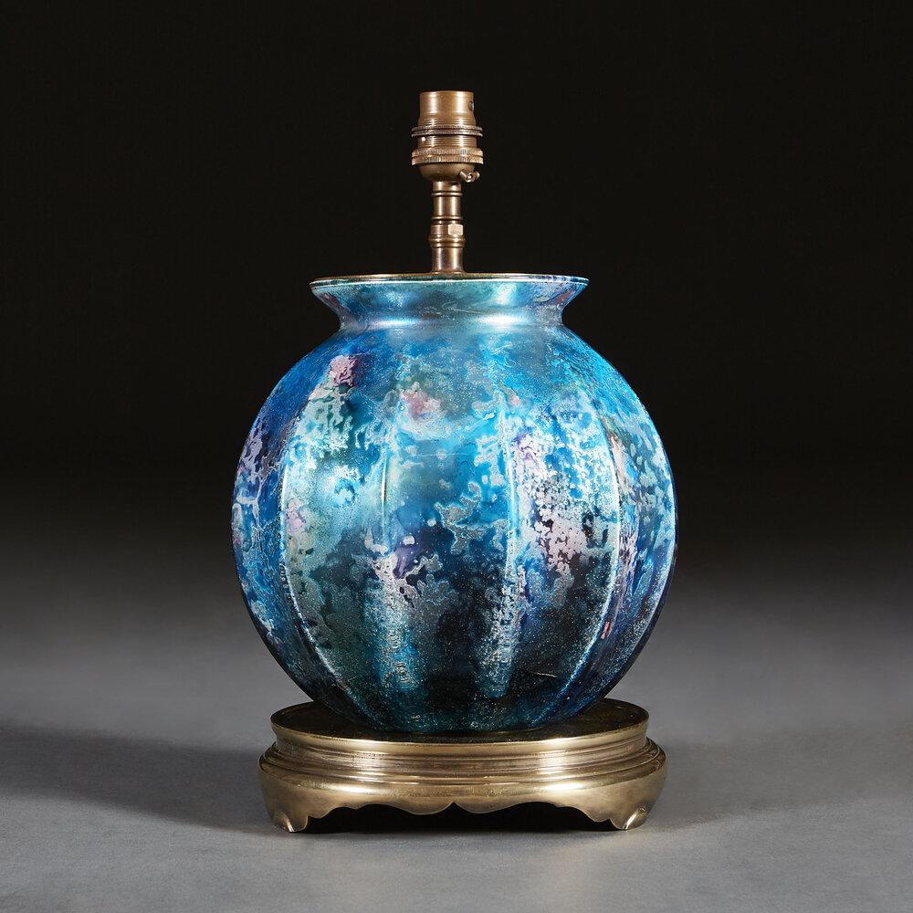 An Iridescent Art Glass Lamp with Brass Mount