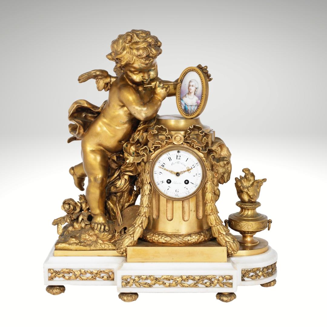 A Louis XVI Style Gilt-Bronze and Sèvres Style Porcelain Mounted Figural Clock