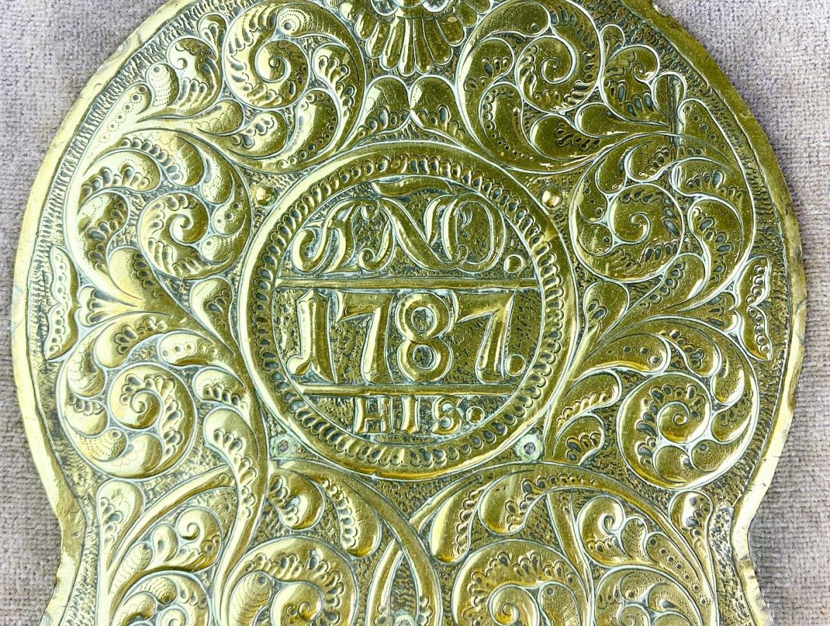 Repoussé brass saddle decoration dated 1787. Spanish, circa 1787