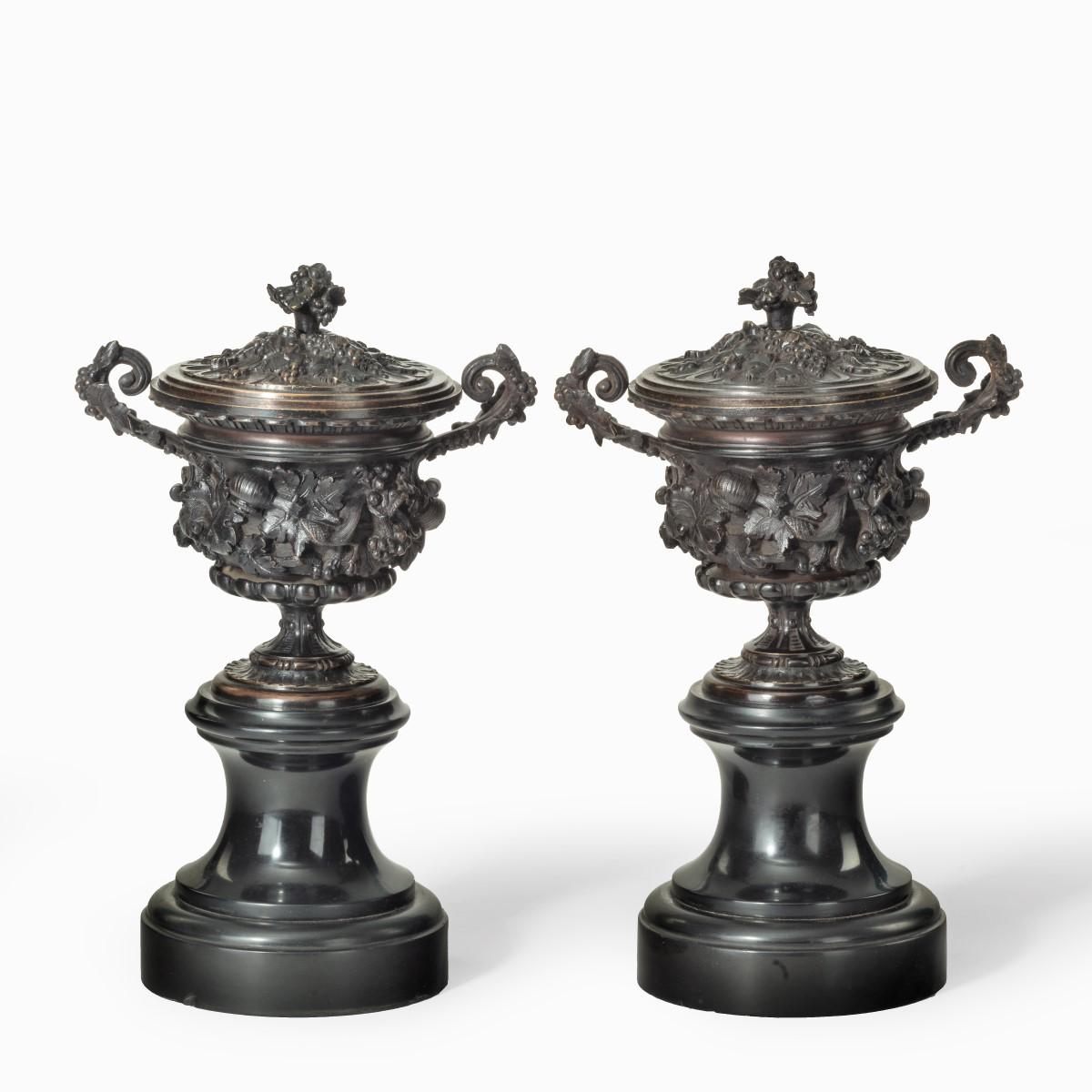 A pair of bronze vases and covers in the classical style