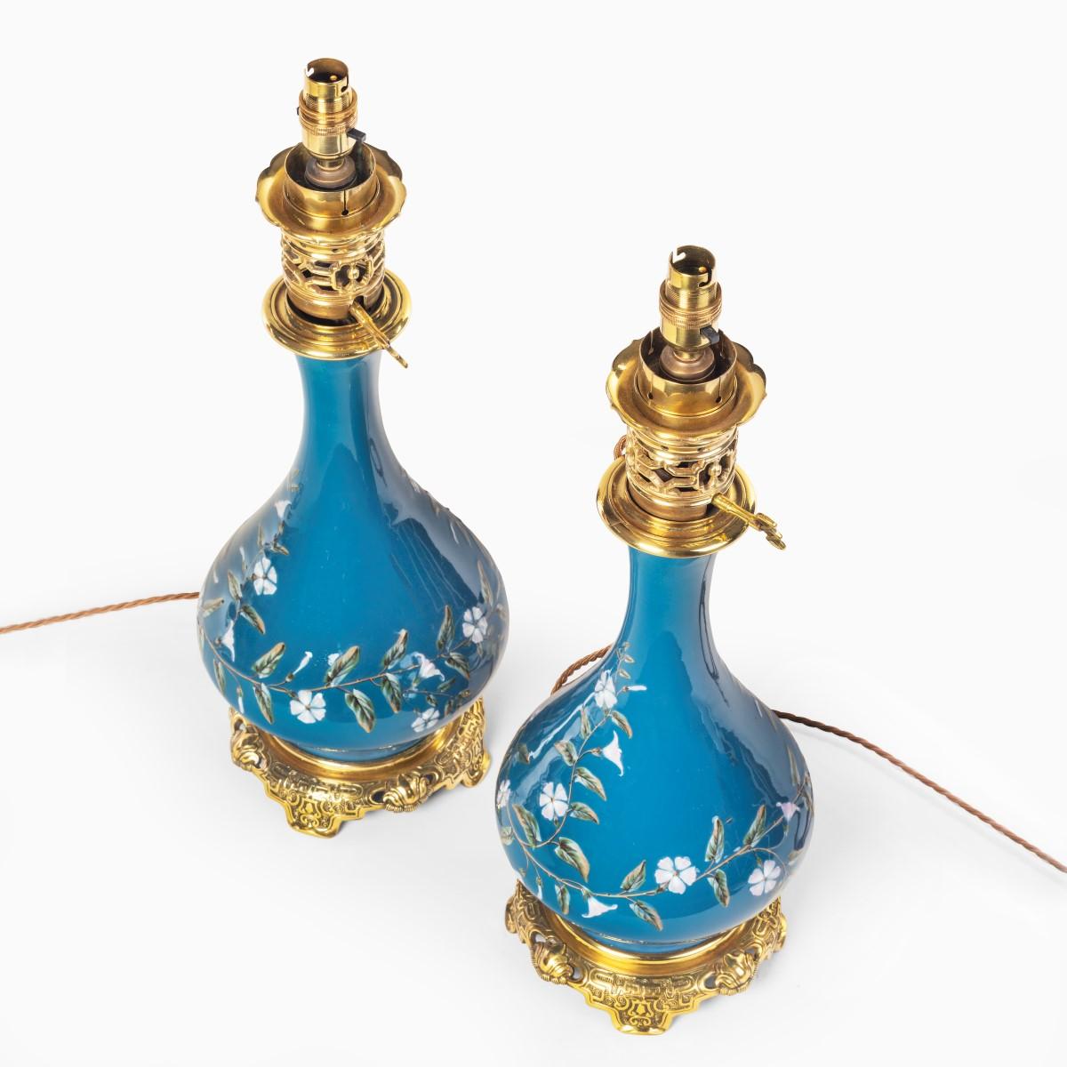 A pair of French pate-sur-pate ceramic oil lamps