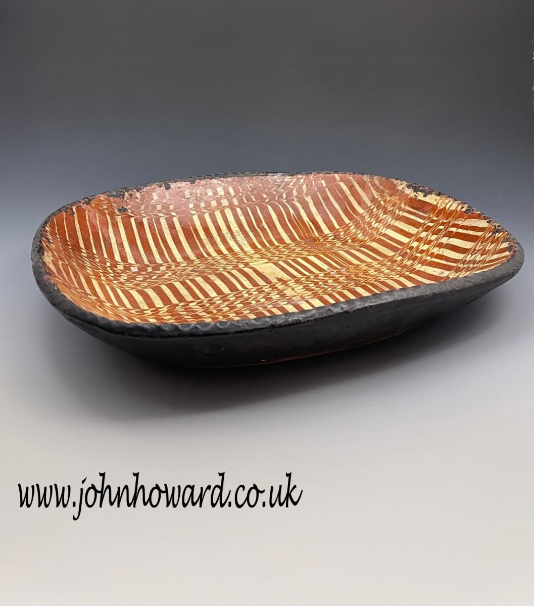 English slipware earthenware baking dish with striking comb decoration late 18th century