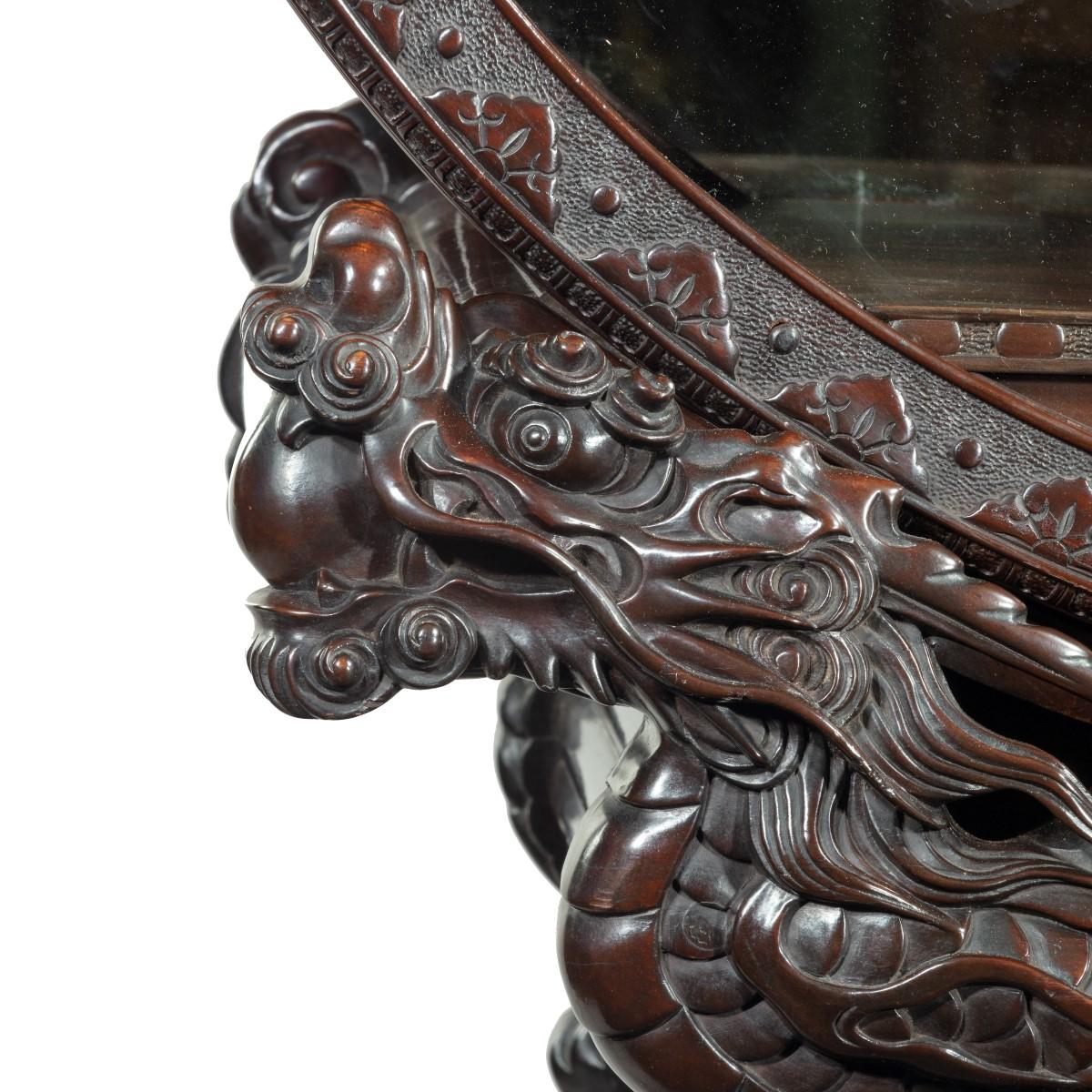 A Meiji period carved hardwood circular display cabinet