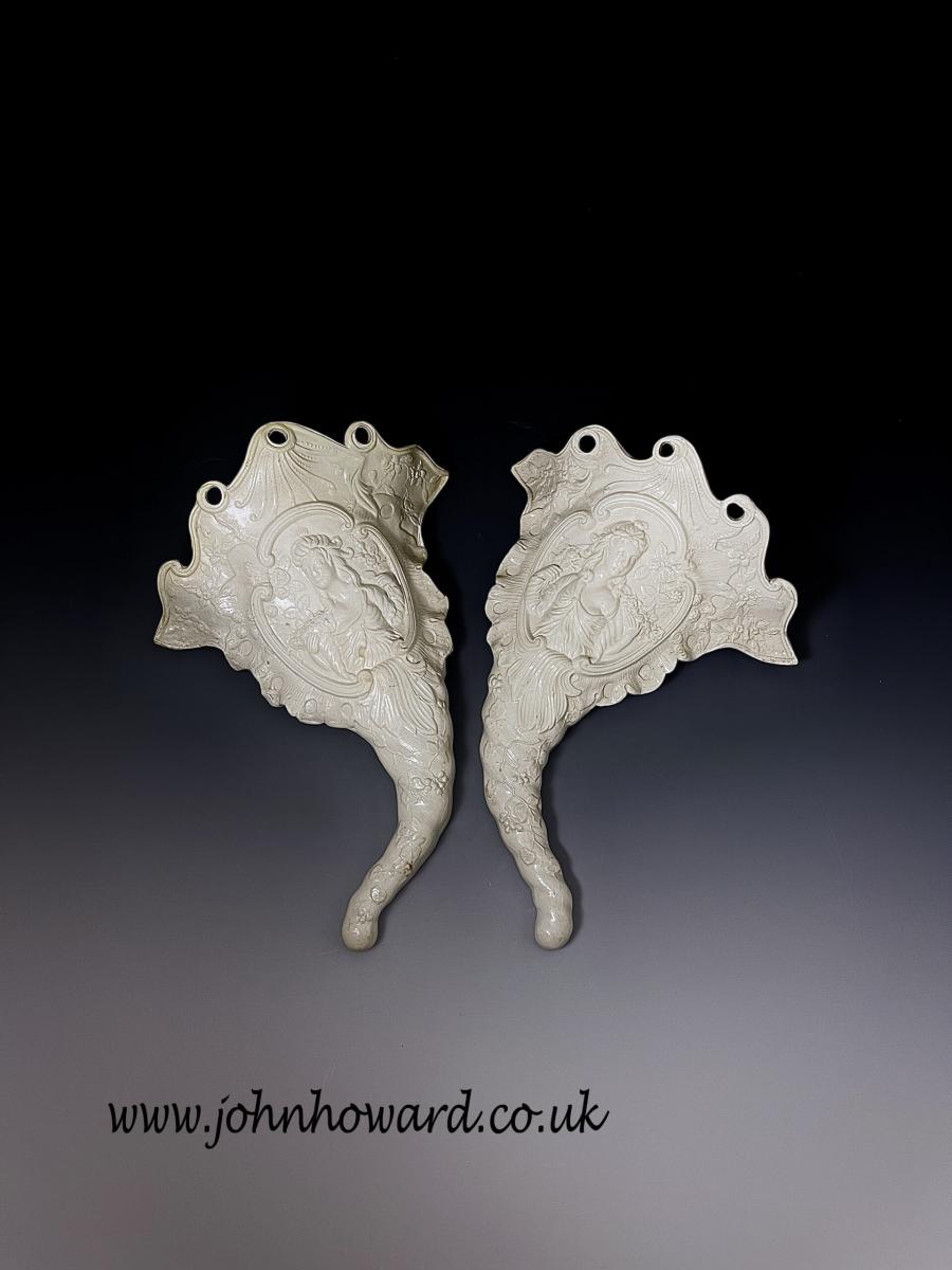 Pair of white saltglaze stoneware wall pockets with image of Flora Staffordshire 18th Century